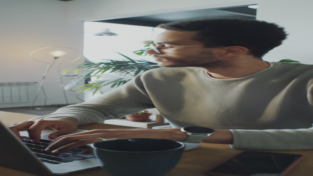 Man Working on Laptop in Home Office
