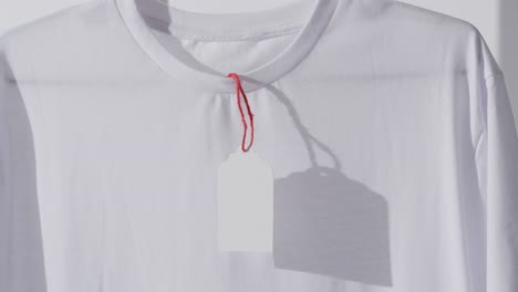 video of white t shirt with tag and copy space on white background