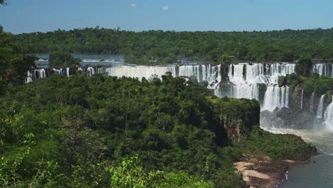 Iguazu-Falls-Waterfall-in-Argentina,-Wide-Beautiful-Waterfall-Landscape-Spread-From-Amazing-High-Up-Rainforest-Jungle-View,-Beautiful-Vantage-Point-From-Tall-Green-Trees-in-Iguacu-Falls