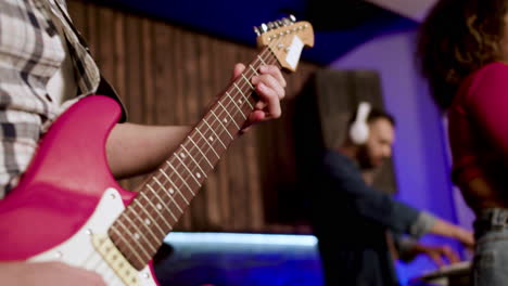 close up view of hands playing a guitar