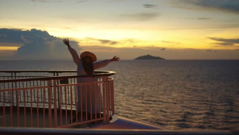 Happy-Asian-Muslim-Woman-Dancing-While-Enjoying-Sunset-From-Upper-Deck-Cruise-Ship