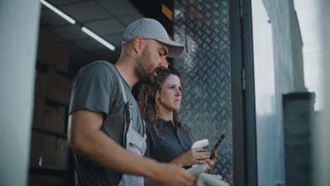 logistics workers managing inventory and deliveries with scanner and tablet