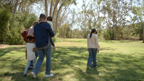 Multi-generation-black-family-preparing-for-picnic-in-a-park