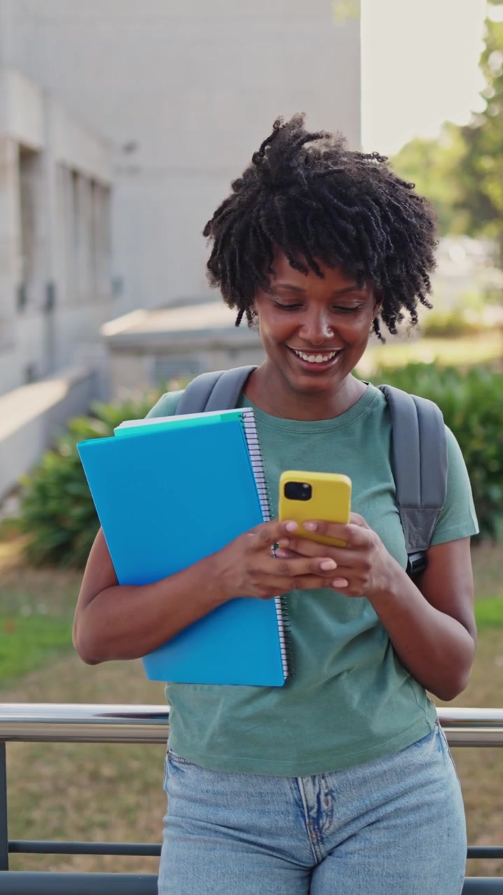 Happy African American Student Using Smartphone on Campus