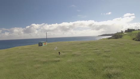 drone boy with flag in field ocean