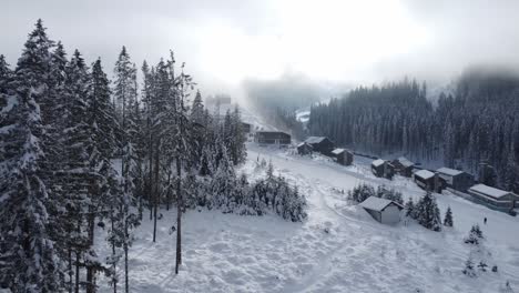 Drone-shot-of-ski-slopes-and-misty-mountains