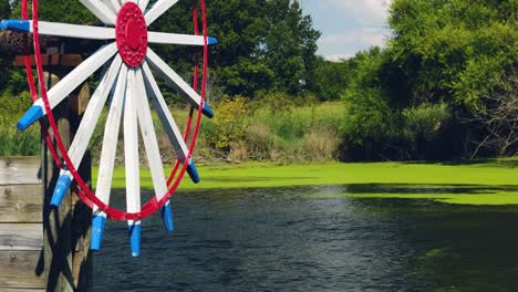 dutch water wheel along the summer day stream