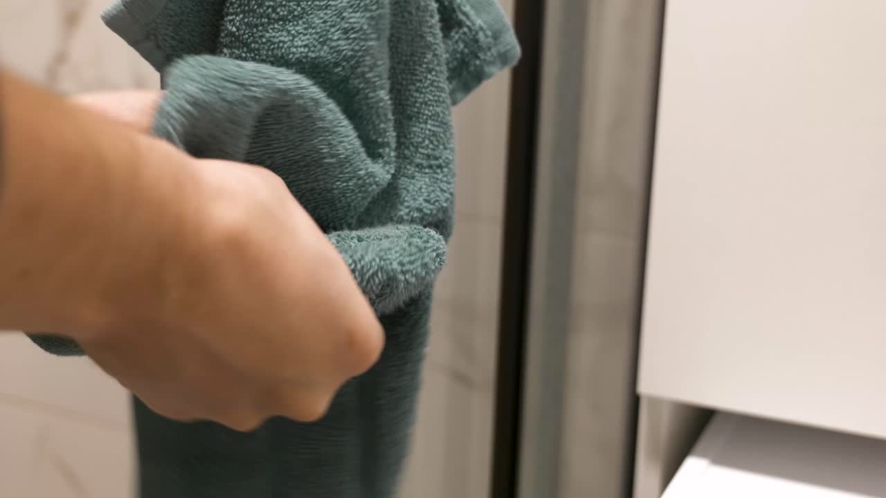 Close-Up Of Drying Hands with a Soft Teal Towel