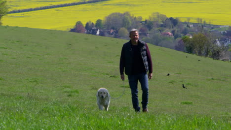 Mature-Man-Takes-Dog-For-Walk-In-Countryside-Shot-On-R3D