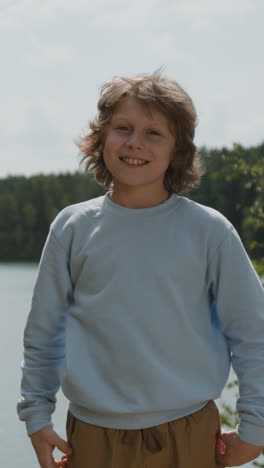 boy smiling by the lake