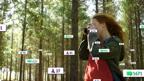 female photographer using dslr camera in pine forest with floating icons for digital marketing