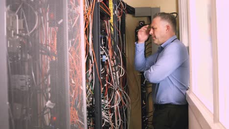 technician looking at open server locker