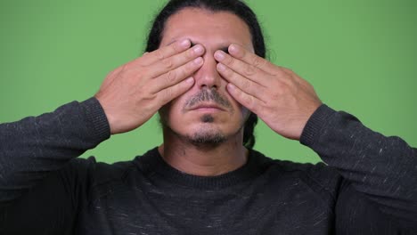 handsome man covering eyes as three wise monkeys concept