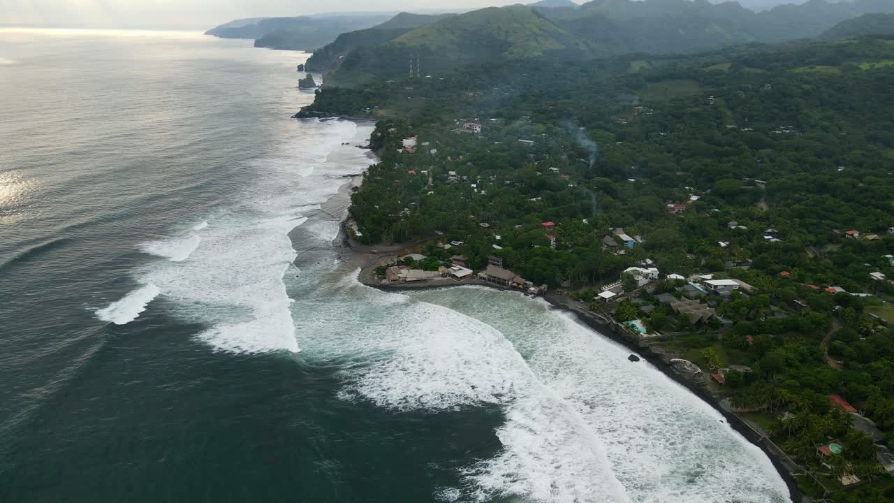 vista aérea en movimiento, vista panorámica de la playa bitcoin en el salvador, méxico, puesta de sol reflejada en la playa en el fondo