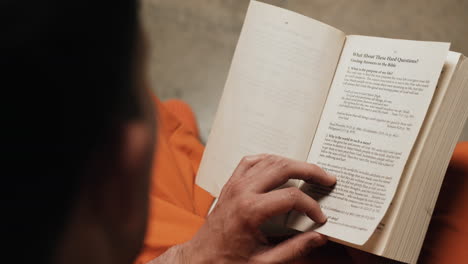 a man in prison reading bible