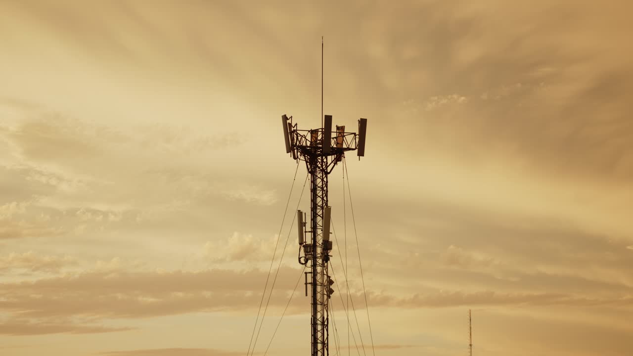 5G Cell tower against a golden sunset sky, standing tall for communication infrastructure
