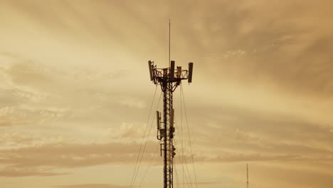 5g cell tower against a golden sunset sky, standing tall for communication infrastructure