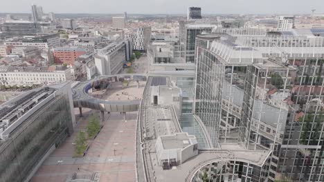 Aerial-drone-fly-above-landmark-in-Belgium-Brussels-European-Parliament-establishing-shot-at-daylight,-skyline-neighborhood-streets-and-buildings