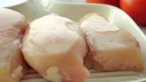 Raw-breast-chicken-meat-on-a-plate-on-white-background