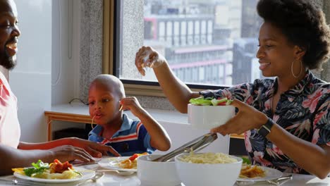 family having food at dining table in a comfortable home 4k