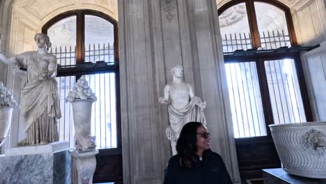 visitors admire ancient statues in paris museum