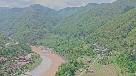 a cable car travels above a flowing river and lush green mountains, offering a stunning view of nature, elevation, and movement. perfect for themes of travel, exploration, and scenic transportation