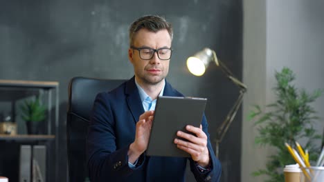 businessman in glasses using tablet in the office 1