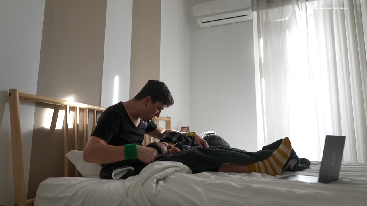 Man and Child Relaxing in Bed