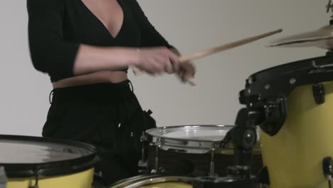 caucasian girl with a deep neckline plays the drums