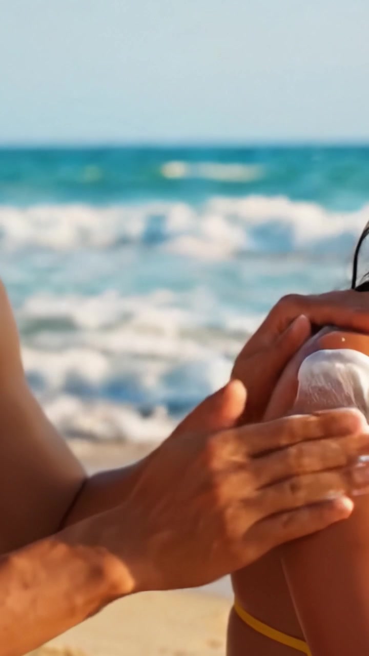 Applying Sunscreen on the Beach: A Careful Ritual for Skin Protection Under the Sun's Intense Rays