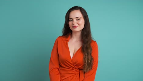 beautiful woman in orange dress smiling at camera