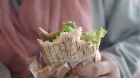 woman eating a sandwich