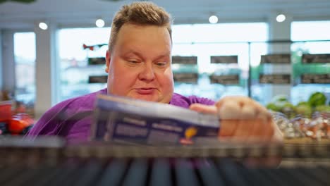 filming in brest and a man approaches the counter and takes a box of sweets from there. a man selects a box from the counter