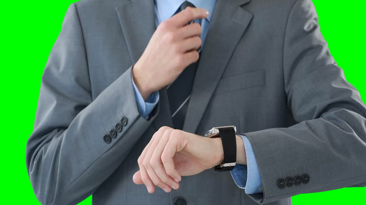 Mid-section of businessman using smartwatch