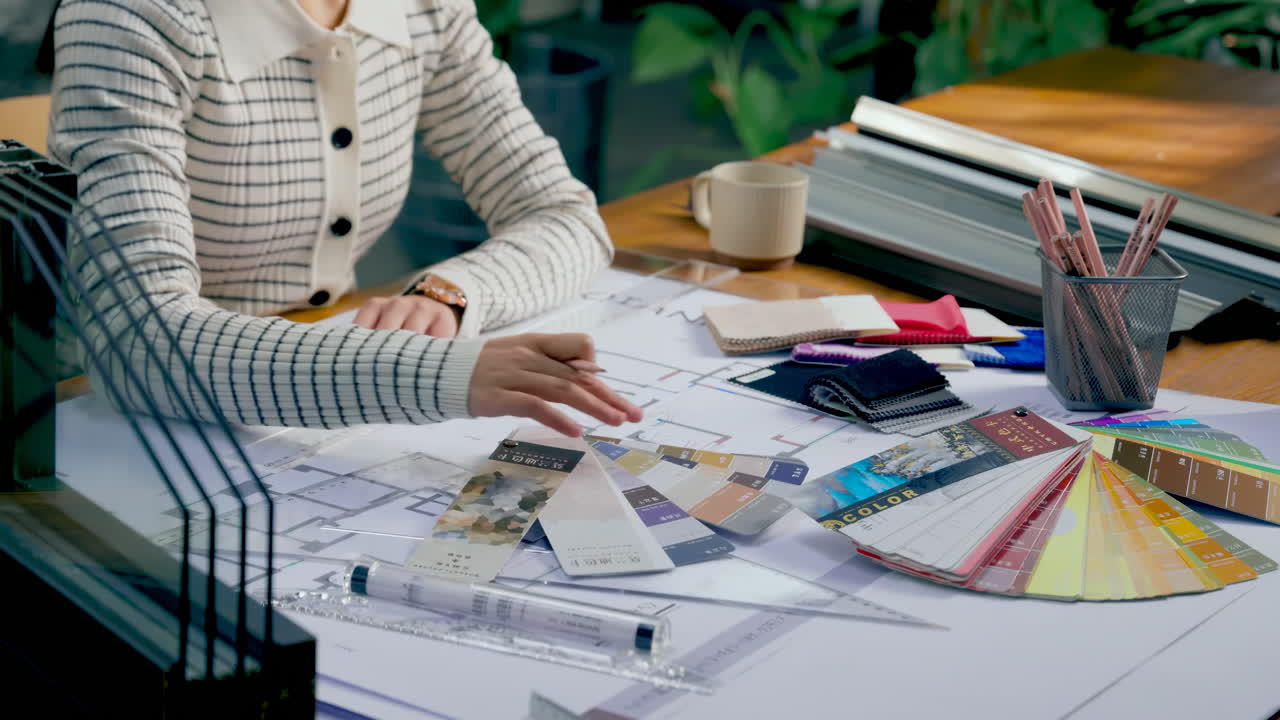 Professional designers working confidently making some sketches while using color palette and graphic tablet at creative modern workplace office