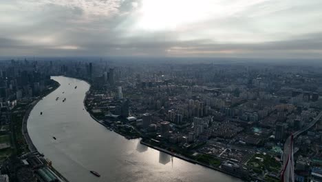 drone aerial view of buildings, cityscape and river in downtown