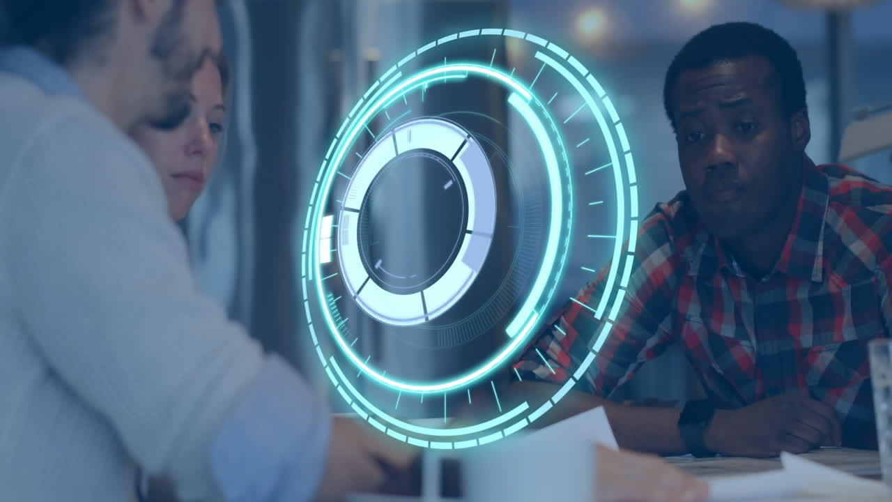 Futuristic digital interface animation over diverse team collaborating in office