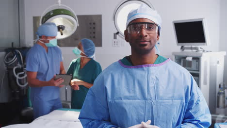 Portrait-Of-Male-Surgeon-Wearing-Scrubs-And-Protective-Glasses-In-Hospital-Operating-Theater