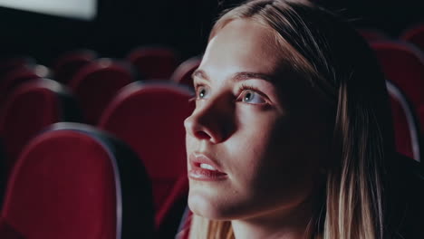 woman watching a movie in a theater