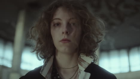 moody portrait of a young woman with curly hair