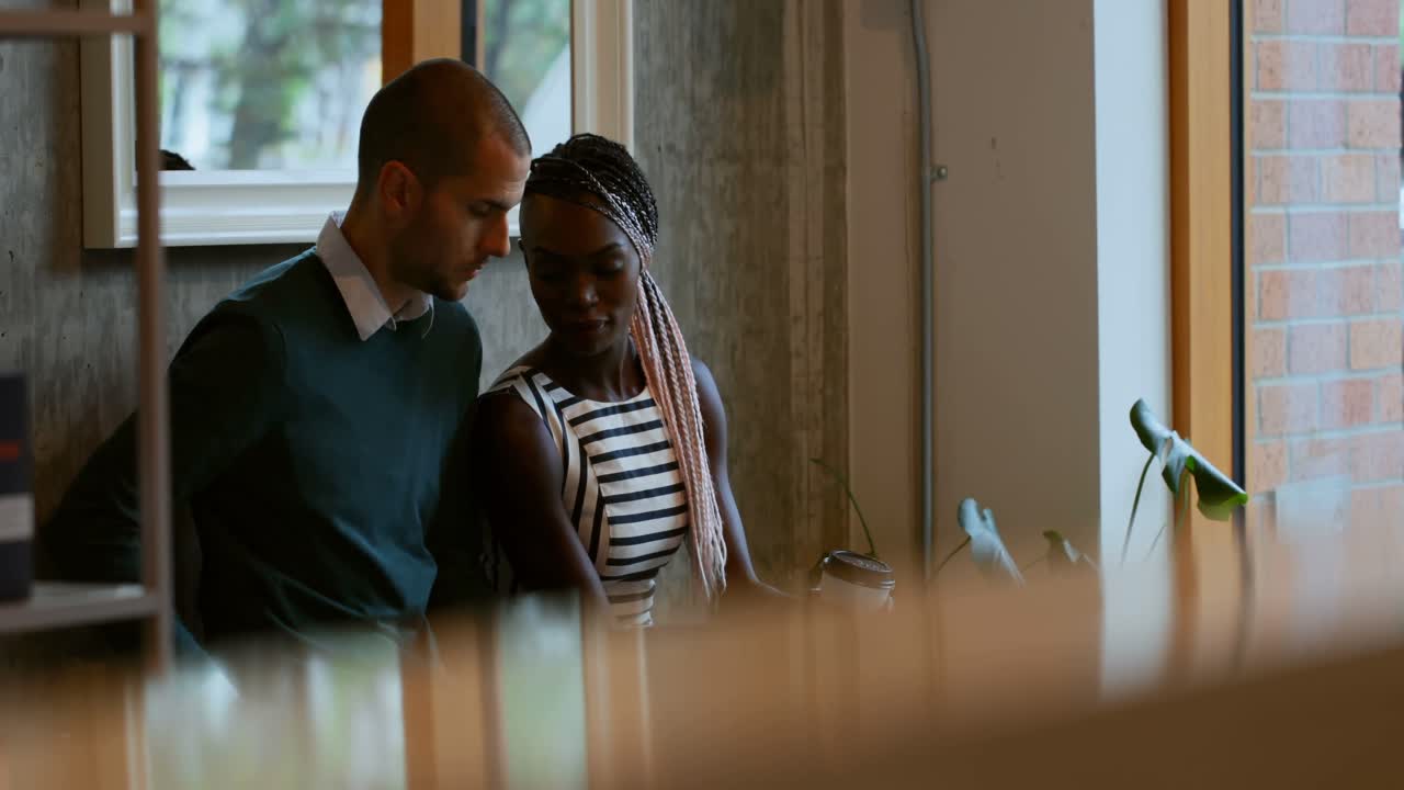 Couple interacting with each other in cafe 4k