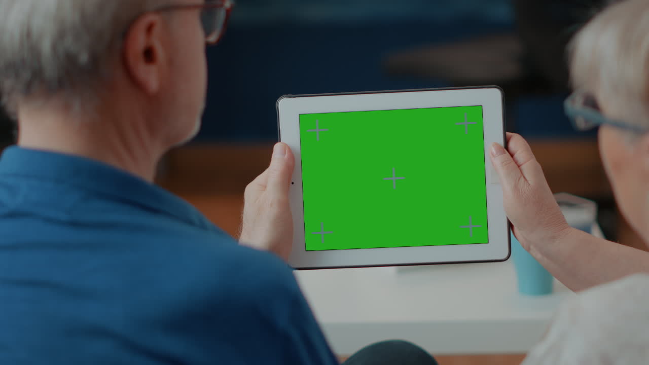 Elderly Couple Holding Tablet with Green Screen