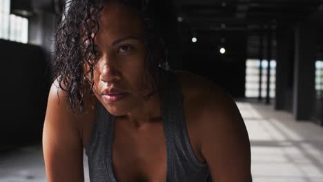 portrait of african american woman taking a break breathing heavily and looking at the camera