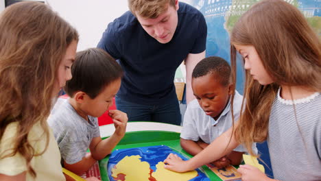 Kids-and-teacher-do-earth-structure-puzzle-at-science-centre