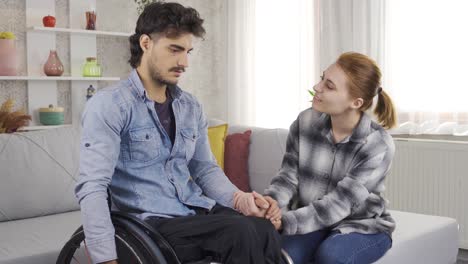 Woman-talking-to-disabled-boyfriend-and-helping-him.