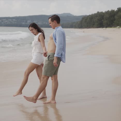 Happy-couple-tourists-having-fun-enjoying-in-sea-beach