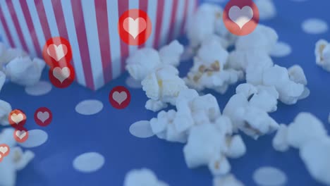 Animation-of-heart-icons-over-box-of-popcorn