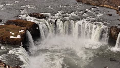 goðafoss, meaning "waterfall of the gods," is a magnificent horseshoe-shaped waterfall on the skjálfandafljót river, near laugar in north iceland. its powerful cascades plunge into a deep chasm.