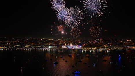 aerial view of new years eve fireworks on the coastline of lisbon city, night
