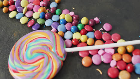 Video-of-colourful-lentils-and-lollipop-on-grey-background